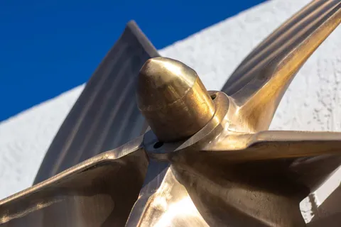 Close-up of the hub and blades of a polished bronze propeller