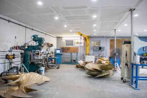 Row of bronze propellers beside the shop’s milling machine