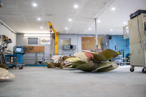 Fouled propellers just in, sitting beside finished work on the shop floor