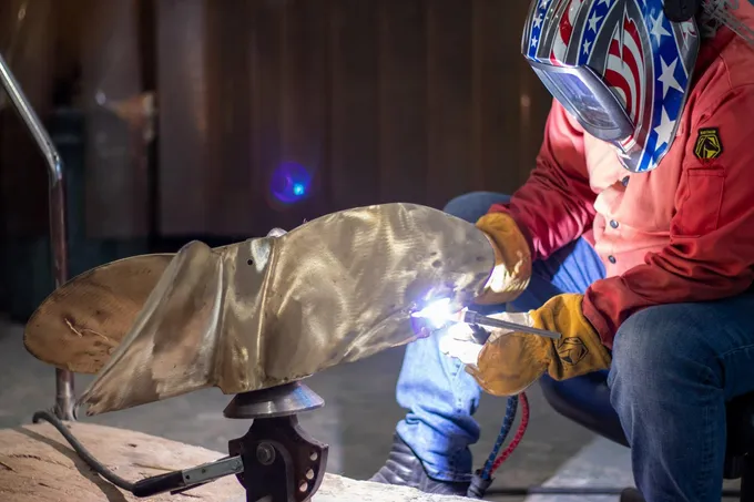 Mrs G Propeller technician TIG-welding a bronze propeller blade